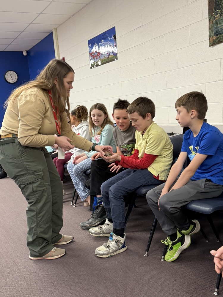 Students holding turtle.