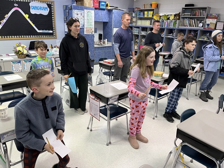 Students and their families participating in an activity 