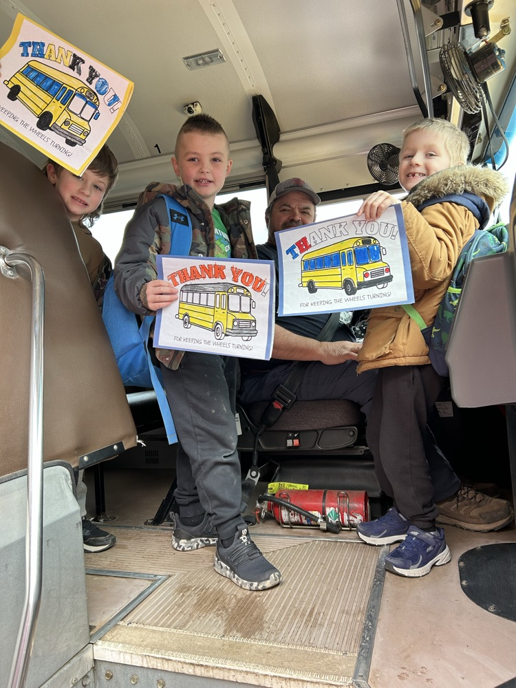 Students standing with their bus driver and their thank you cards! 