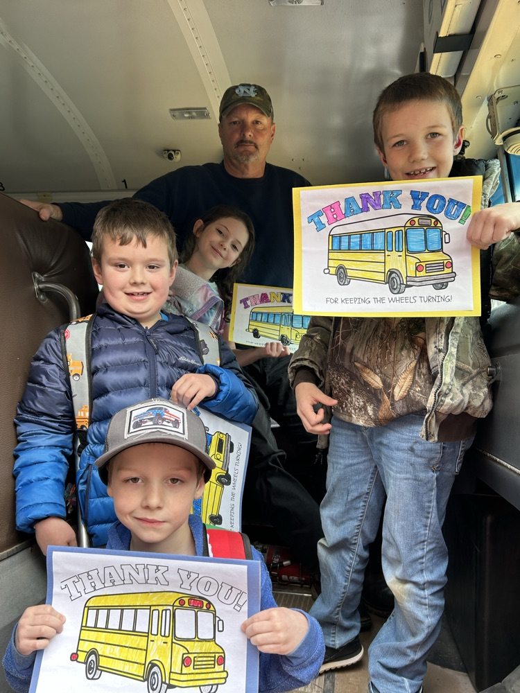Students standing with their bus driver and their thank you cards! 