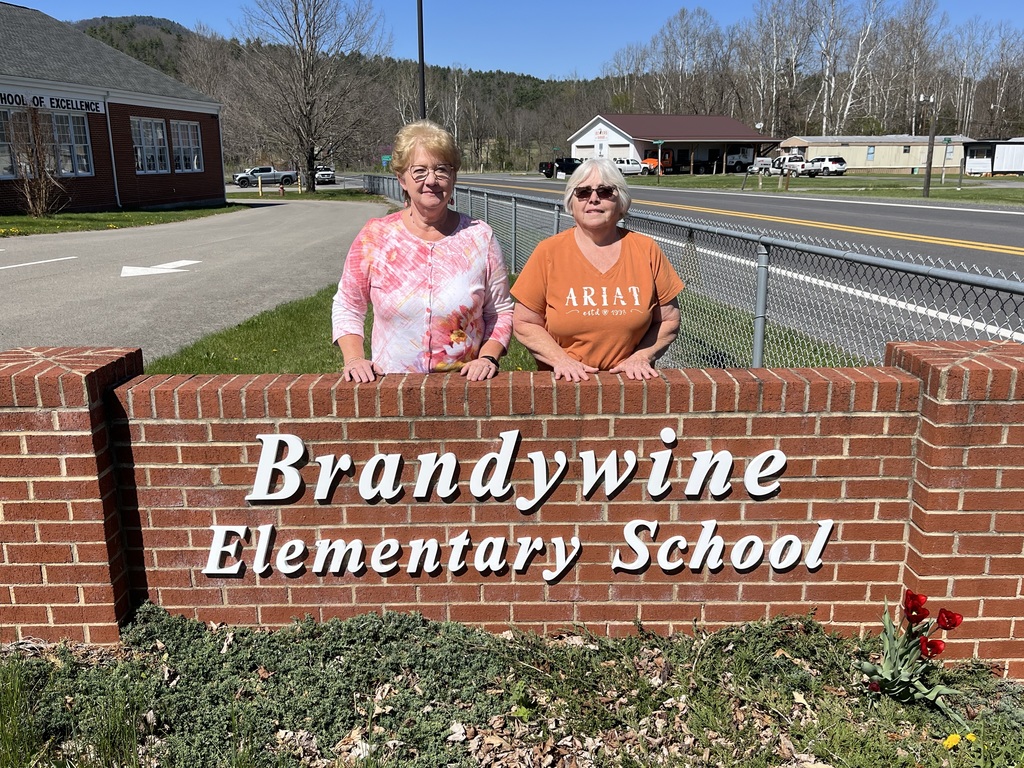 Mrs. Armstrong (teacher of the year) and Mrs. Hedrick (personnel of the year) standing with BES sign.