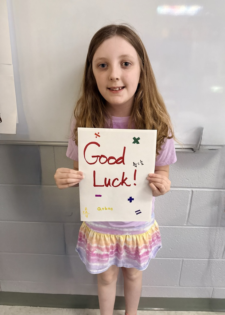State Math Field Day Participant holding card from staff and students