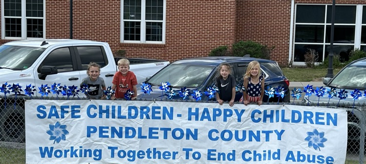 Students with the child abuse banner and pinwheels. 
