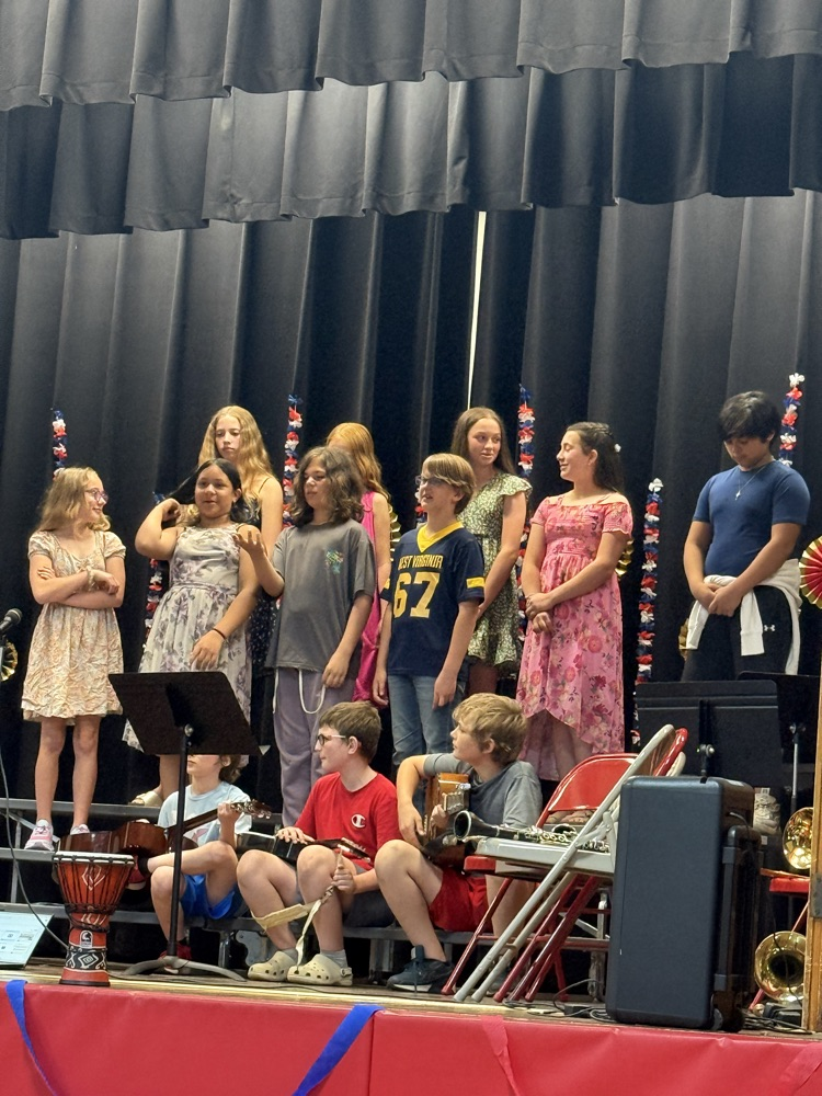 5th and 6th graders singing and playing guitars. 