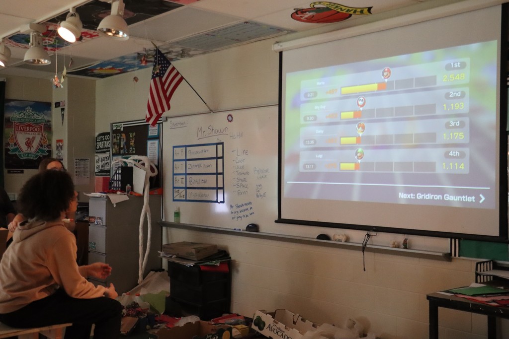 Student playing nintendo switch on elmo in classroom
