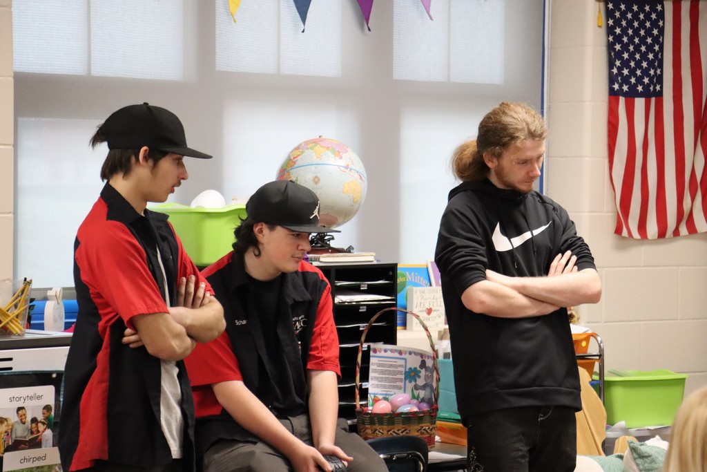 Three CACC students talking to class