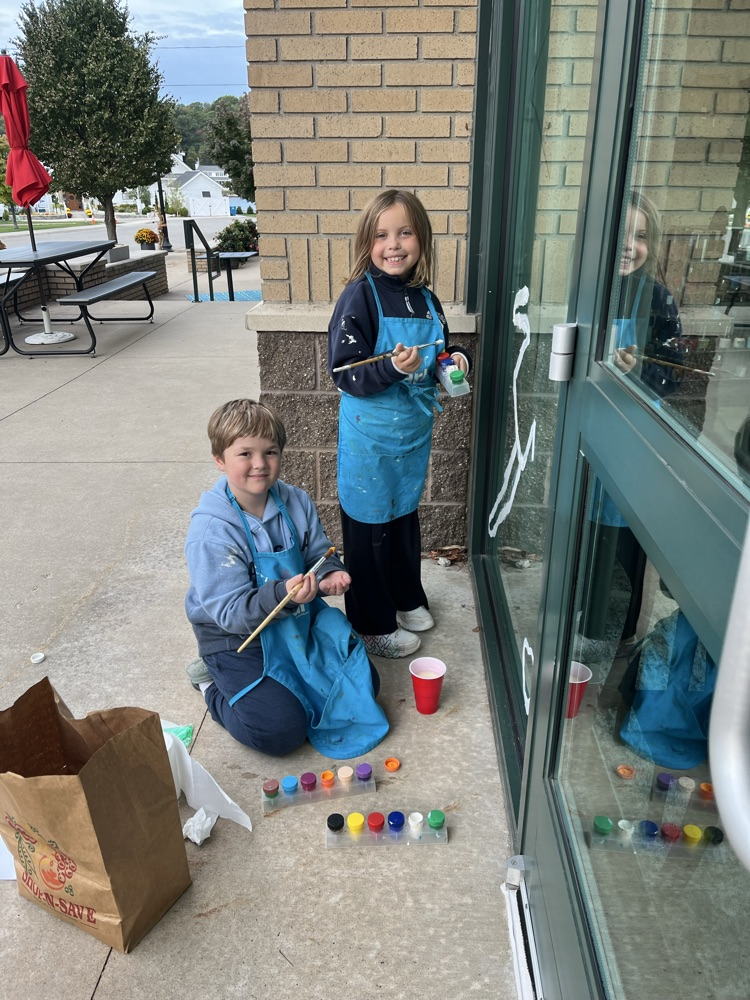 4th graders painting business windows