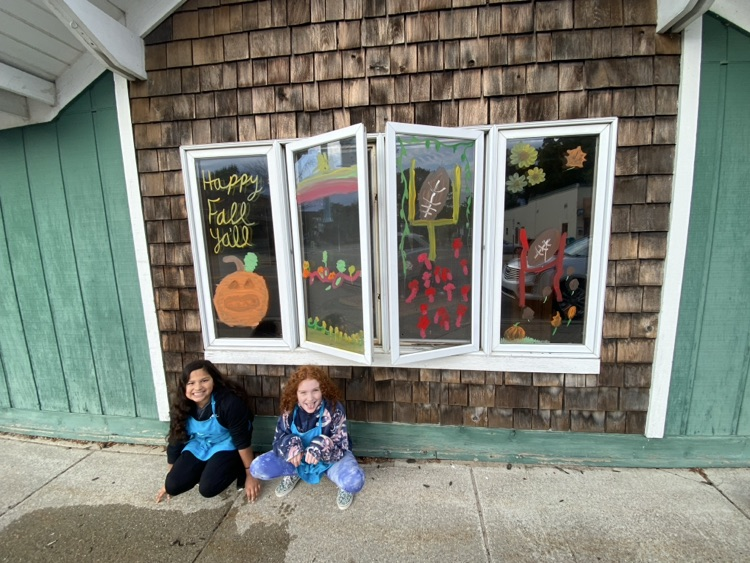 4th graders painting business windows