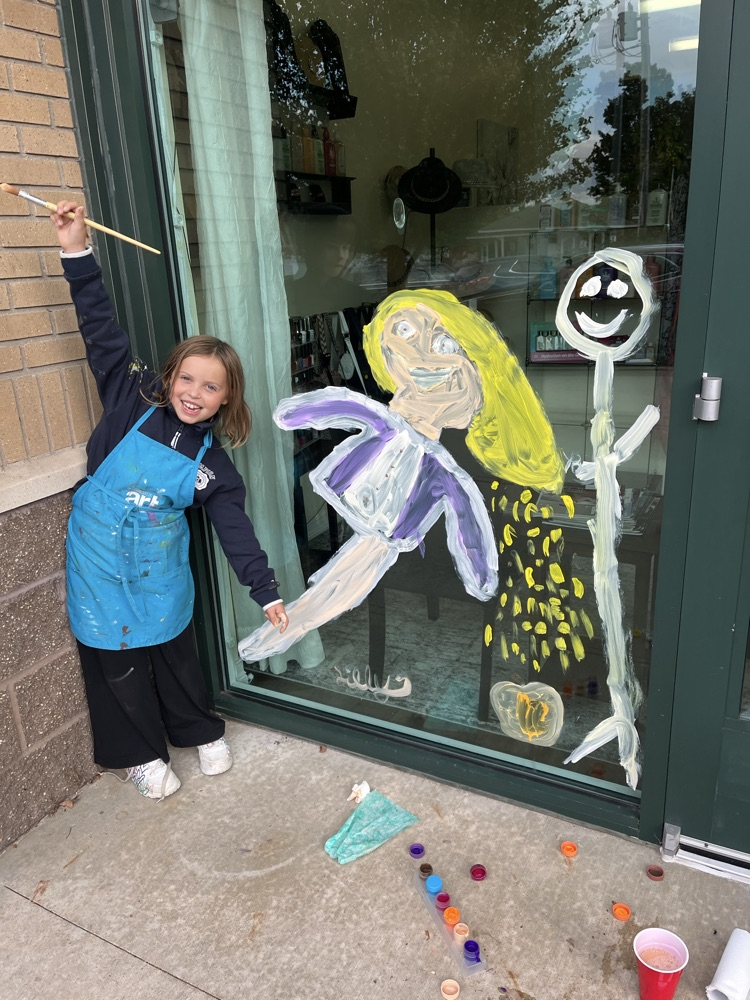4th graders painting business windows