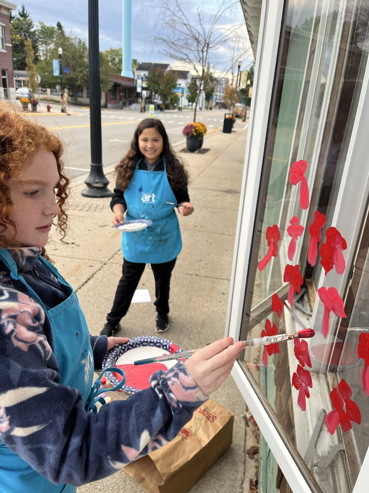 4th graders painting business windows