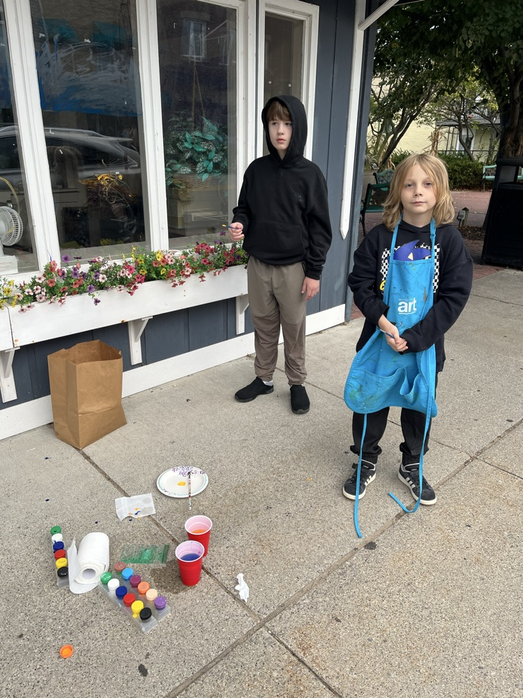 4th graders painting business windows