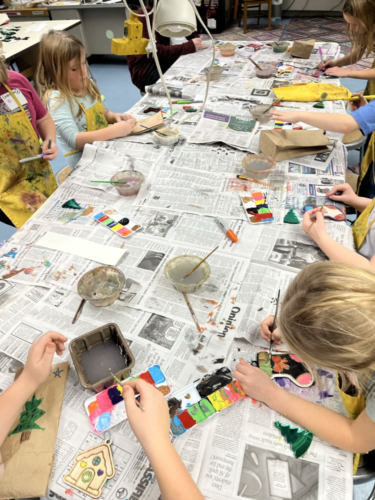 Students painting wooden ornaments 