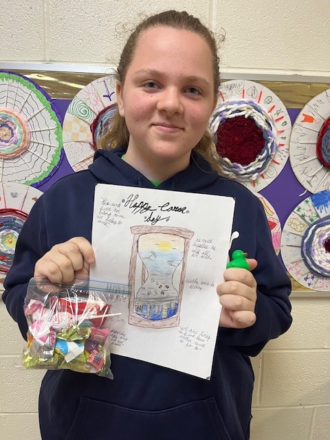 5th grade winner holding art, Hadley Clark