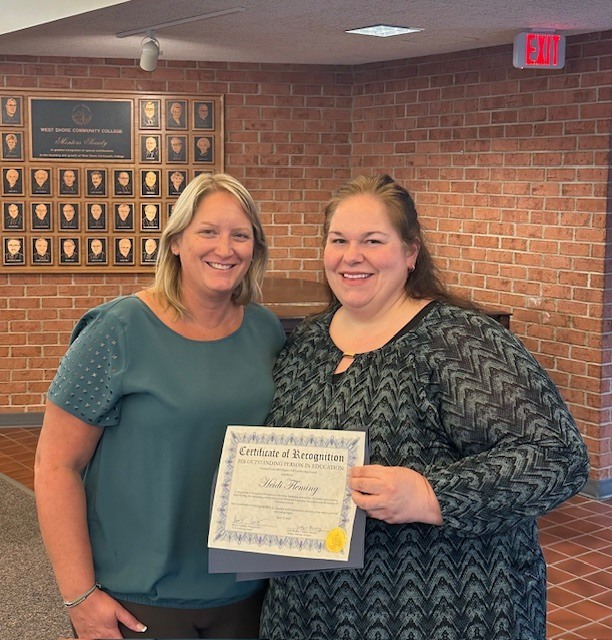 VP Sarah Merten awarding Heidi Fleming with the OPIE Award.