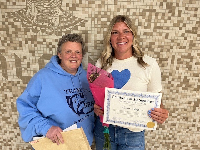 President Donna Miller awarding Cara with her certificate and flowers.