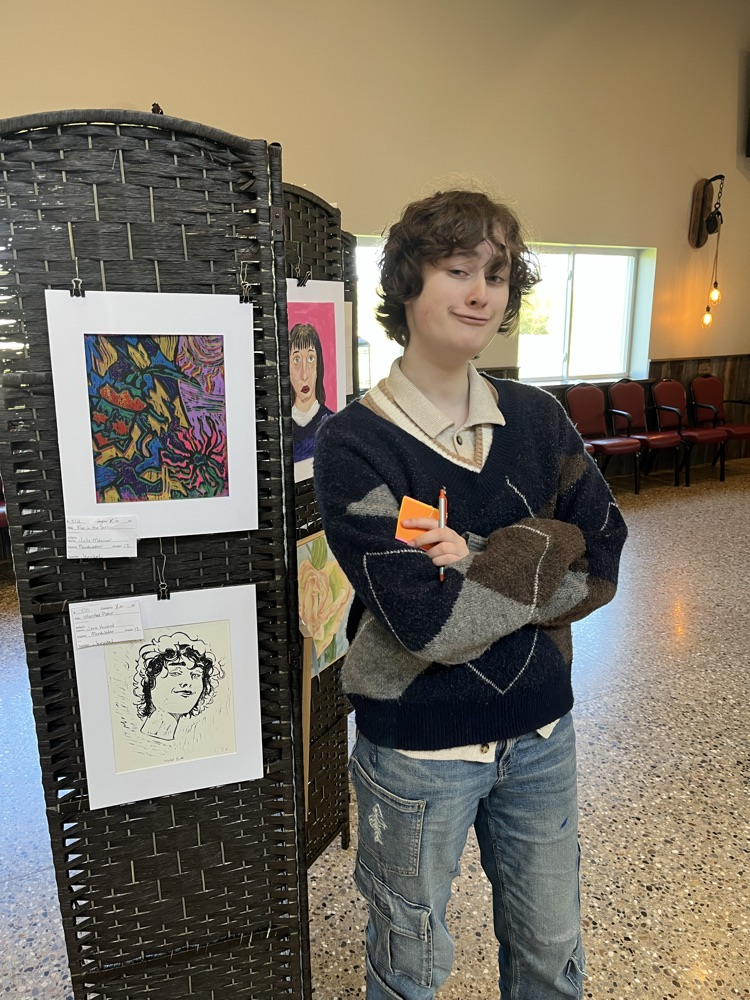 Jane stands in front of her self portrait. 