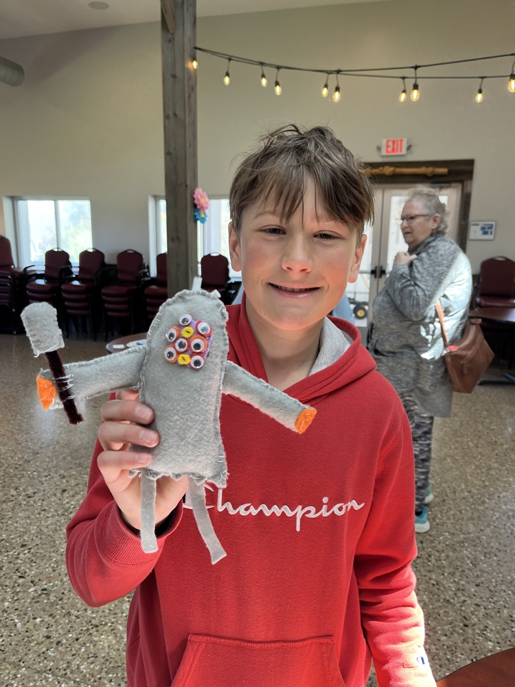 Skyler holds up his soft sculpture. 