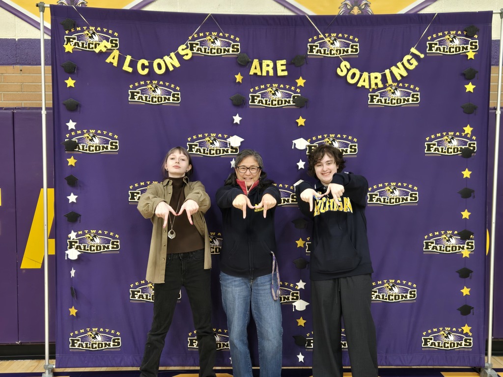 Two students and an adult making an m with their fingers