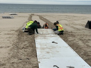 Students at the state park helping put in the sidewalks on the beach