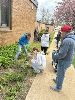 Students doing yard work at the school