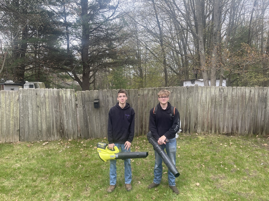 Wyatt and Brayden blowing leaves at a private residence
