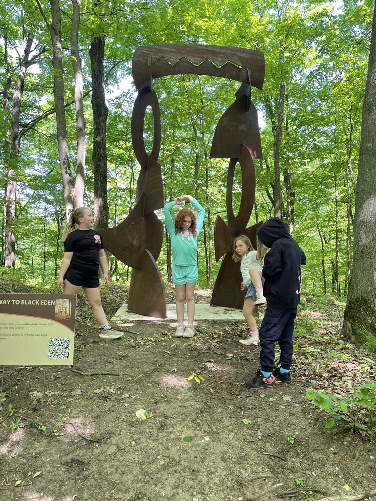 Students make shapes with their bodies like the art at MI Legacy Art Park