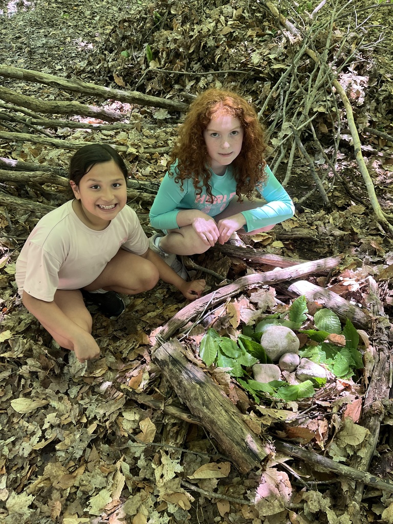 Two students are making a nest MI Legacy Art Park