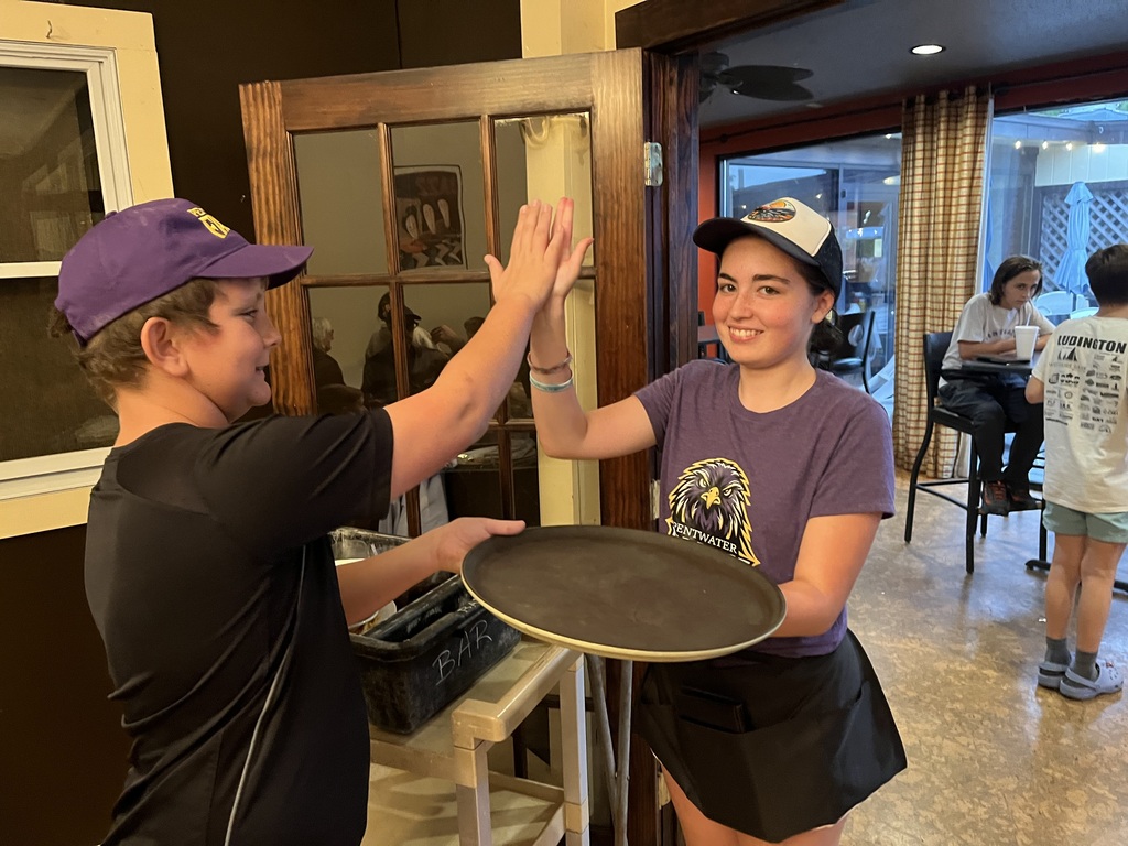 Two students high five.