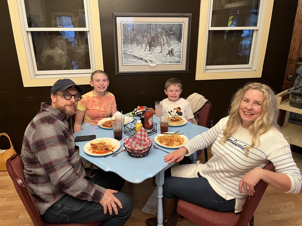 A family eats their dessert.