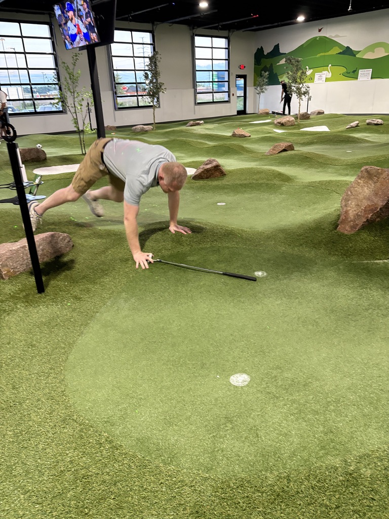 Superintendent Dr McKenna attempting the billiard putt challenge!