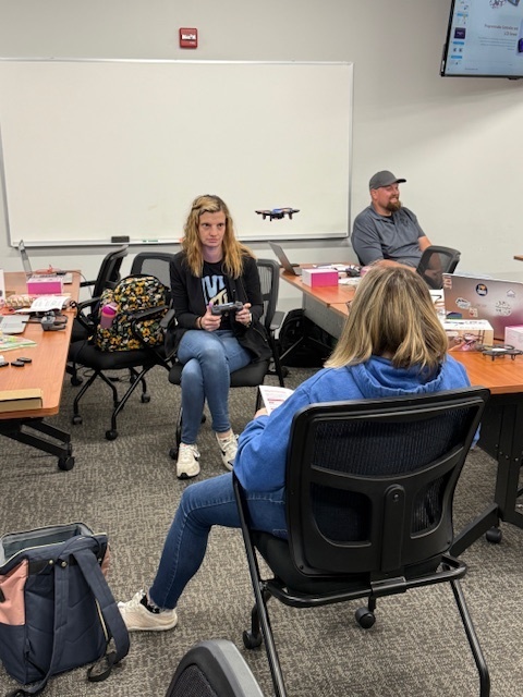 Teacher learning how to fly a drone.