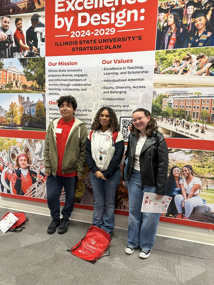 three students in front of a large mural at ISU’s Bone Student Center
