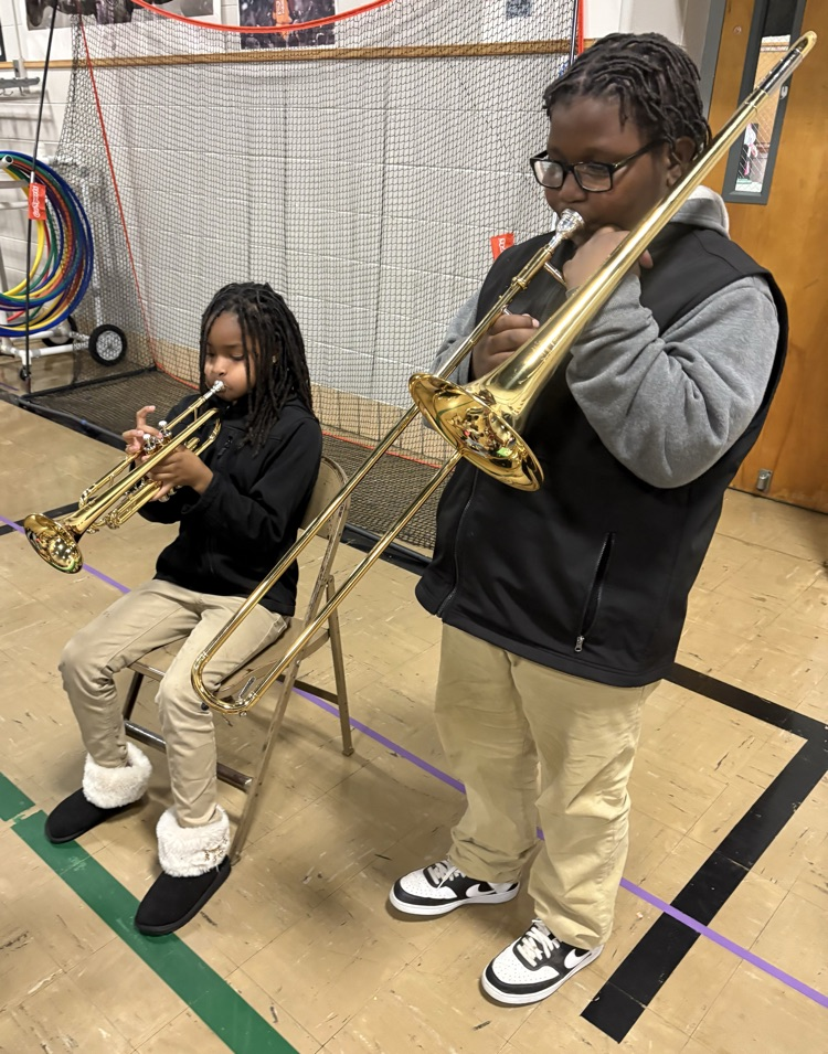 Markell and Neveah modeling good posture and trying out the trumpet and trombone. 