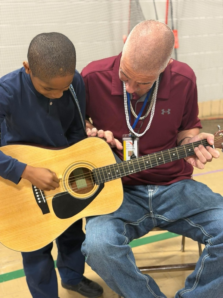 Mr. Schwab taught John his first guitar chord!