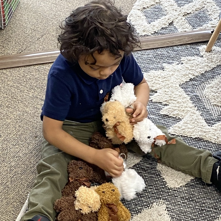 student playing with stuffed toys