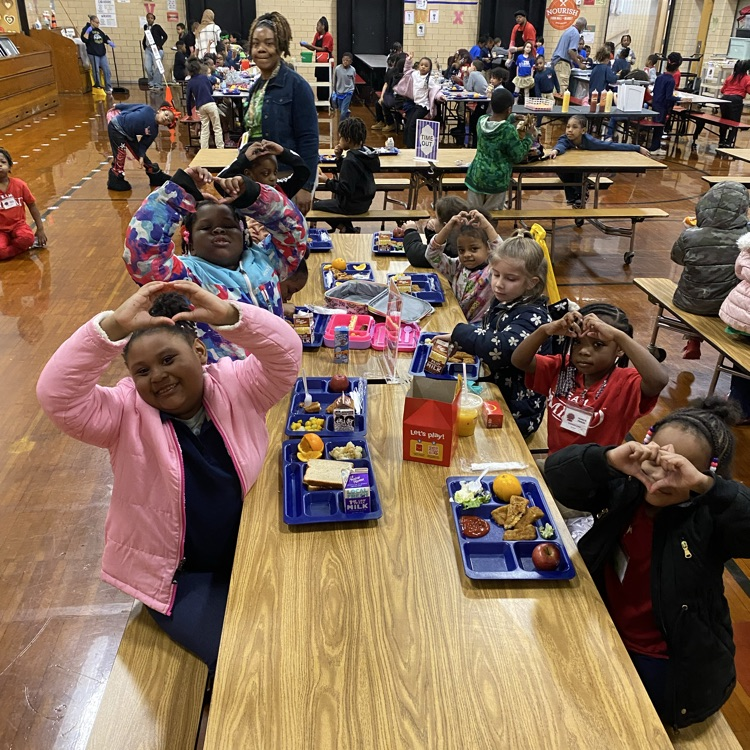 students giving Amistad heart sign