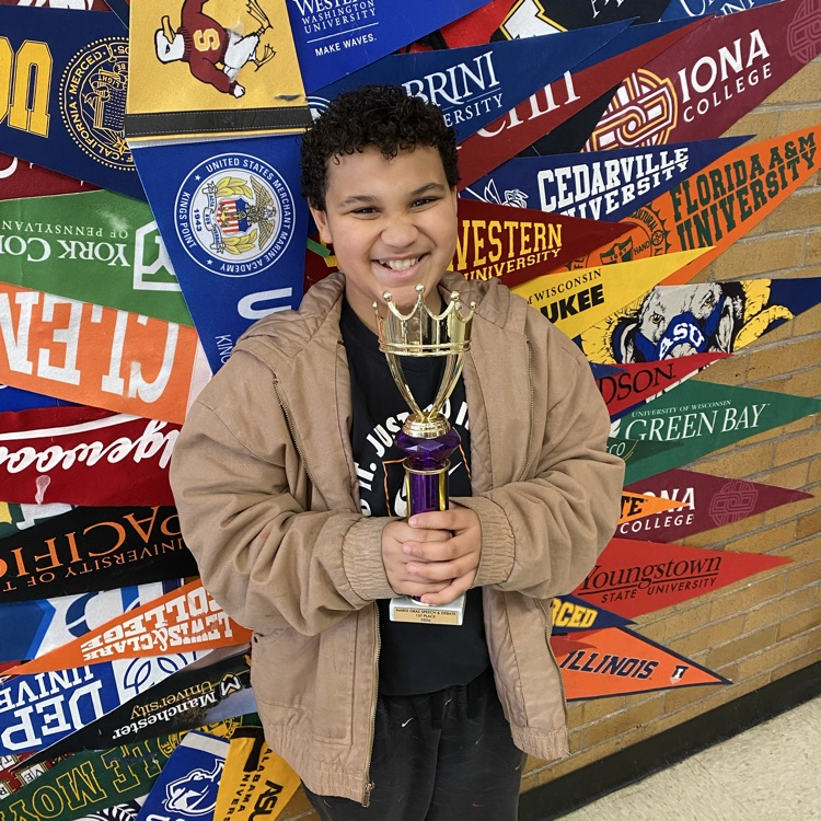 student holding trophy