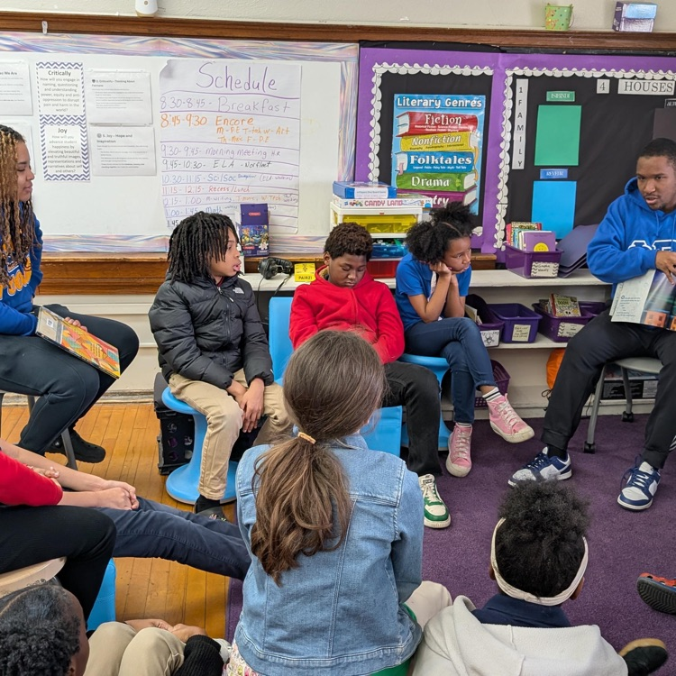 man reading a story to fourth grade class