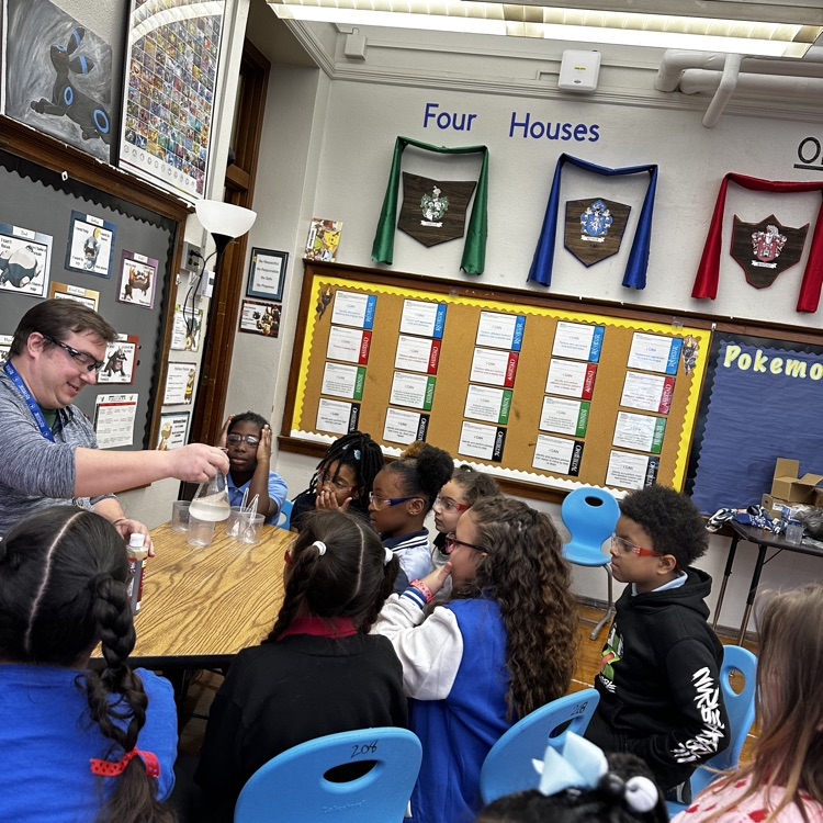 students and teacher conducting an experiment