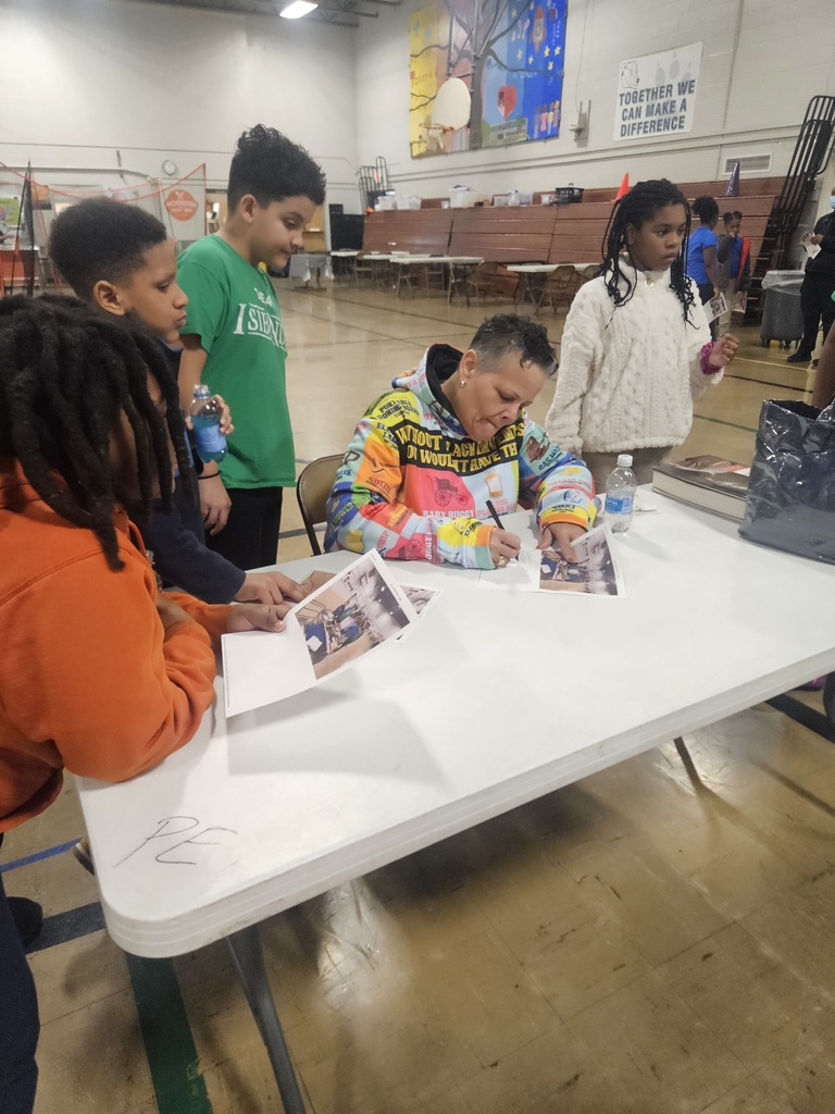 Carol signing pictures for students. 
