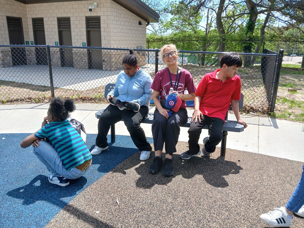 Aide with students on playground