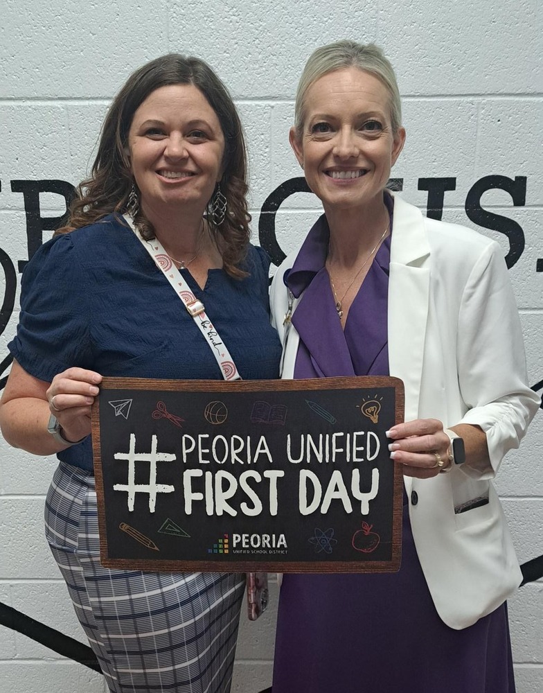 Mrs Jenkins and Dr Hernandez posing with a #FirstDay sign