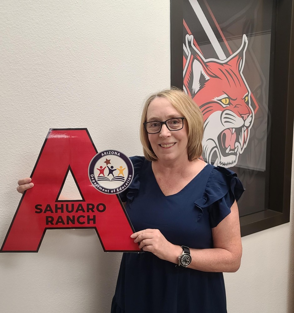 Principal holding letter A sign