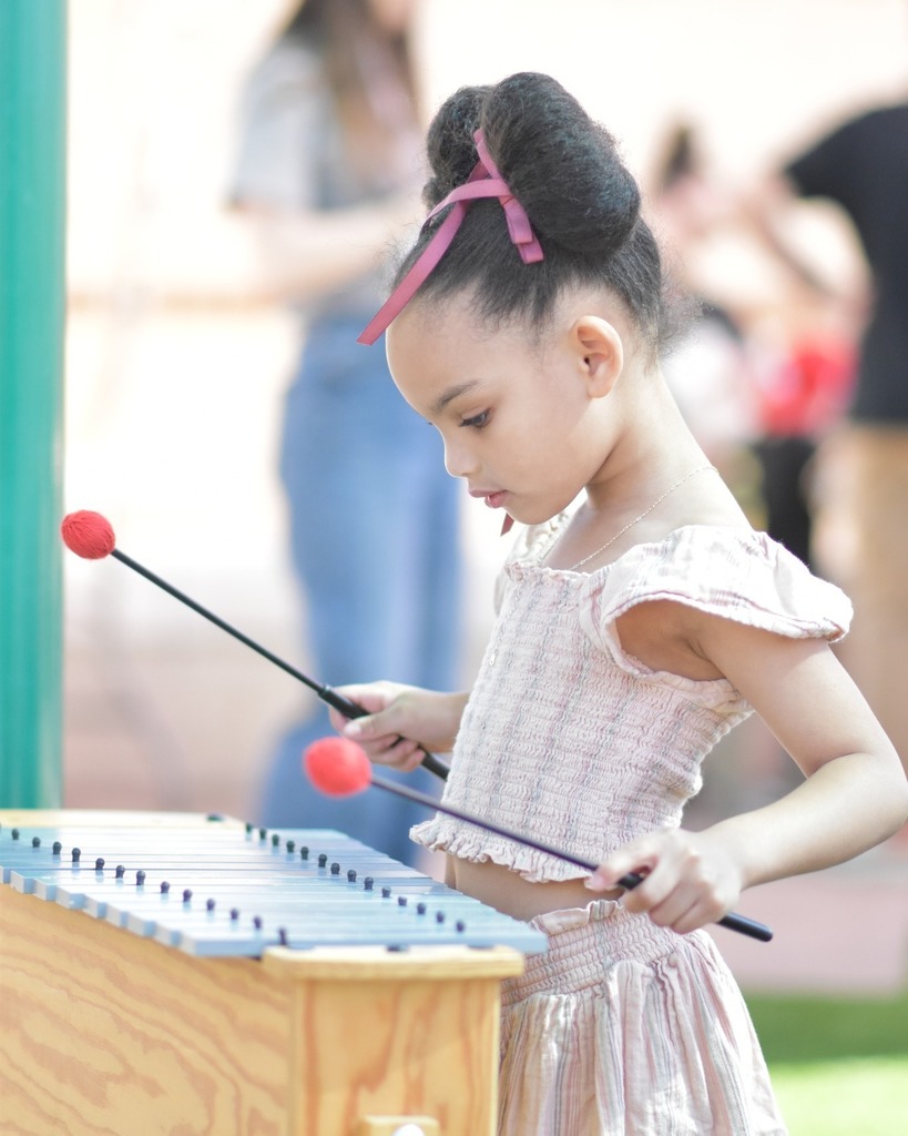 Child playing xylophone at the Peoria Arts Festival