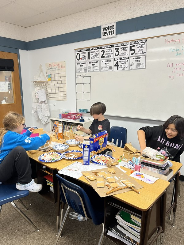 Students building graham cracker homes 