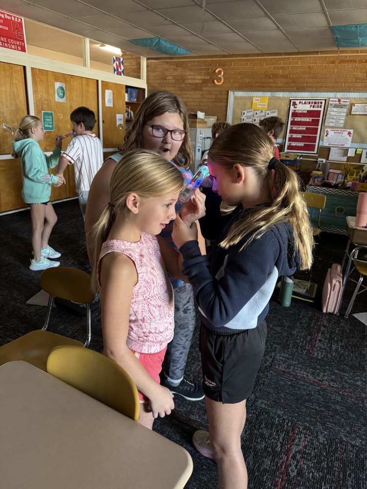 Fourth graders are testing out energy sticks as an end of the unit celebration. They are figuring out different ways to close a circuit.