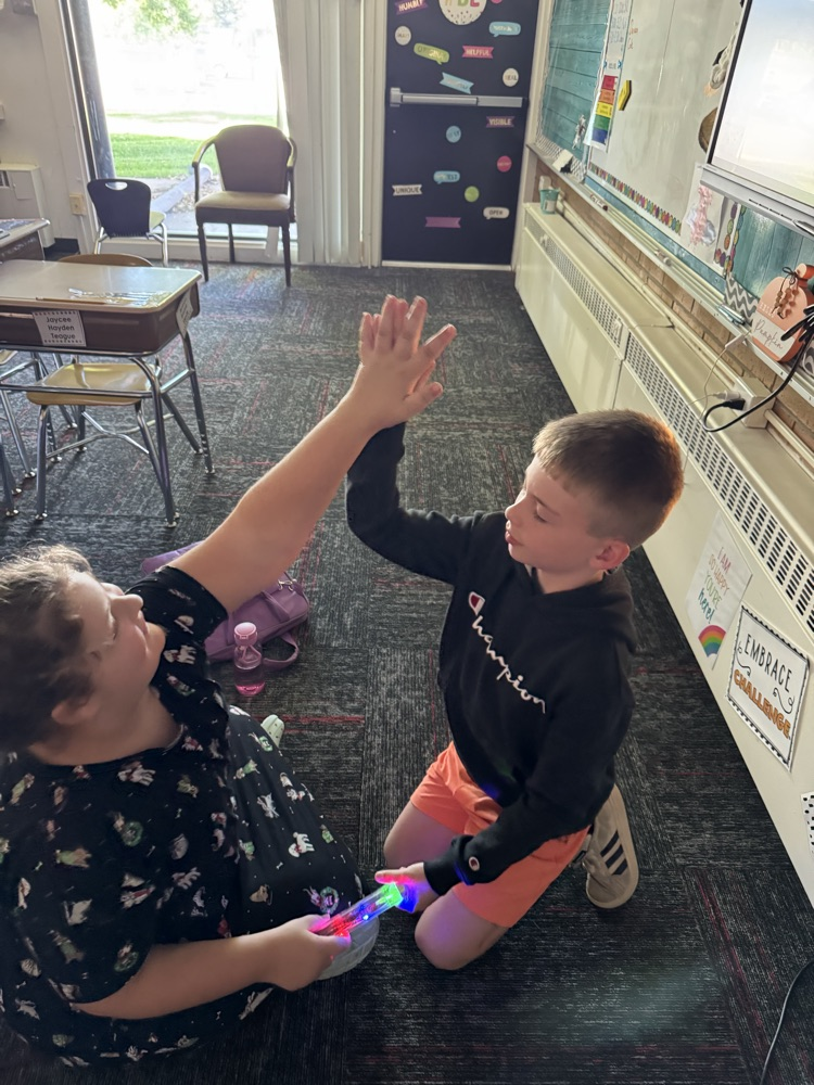 Fourth graders are testing out energy sticks as an end of the unit celebration. They are figuring out different ways to close a circuit.
