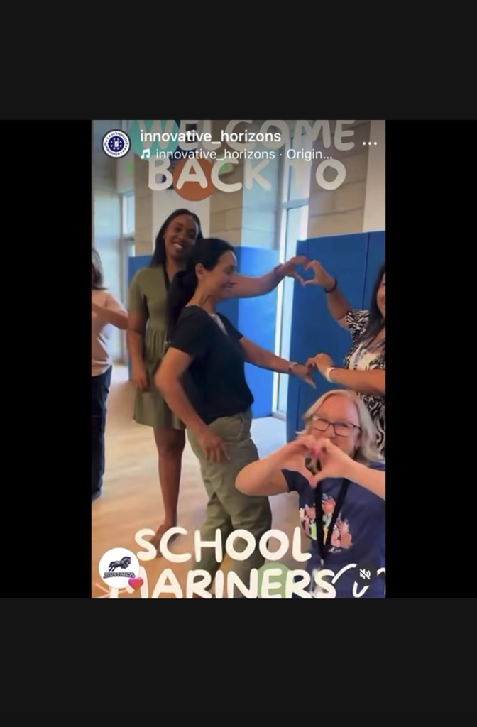 Teachers celebrating the first day, making heart signs with hands