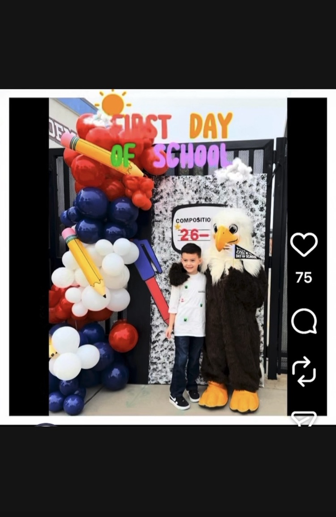 Student posing for a photo with school mascot