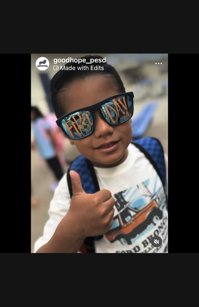 Student with "first day of school" sunglasses making thumbs up sign
